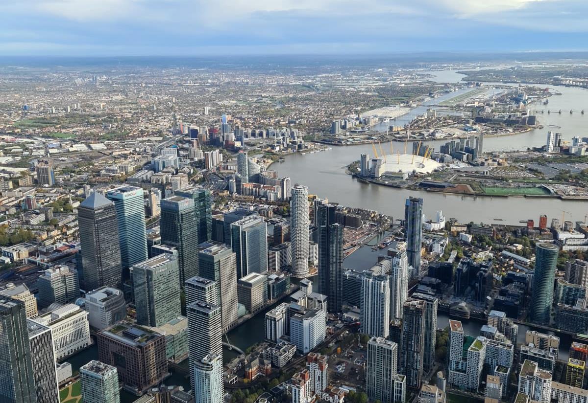 City of London Helicopter Tour - aerial view across Canary Wharf, the Thames and The O2